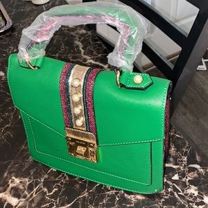 I am selling brand new pink and green glitter aldo purse design with pearls.